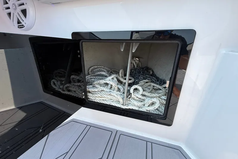 Slide: The Image of Storage compartment with ropes on a 2023 Reef Runner 34CC boat. - 24