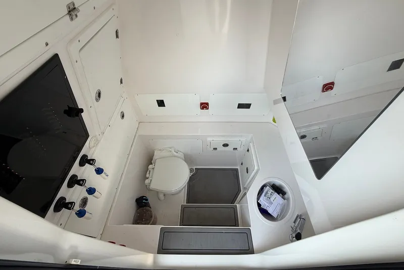 Slide: The Image of 2023 Reef Runner 34CC boat interior with toilet and storage compartments. - 20