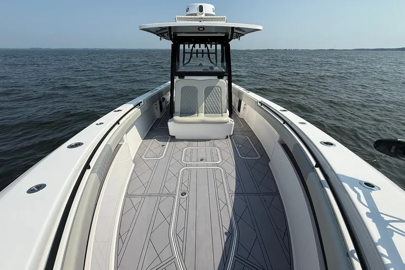 Slide: The Image of 2023 Reef Runner 34CC boat on open water, showcasing spacious deck and seating. - 26