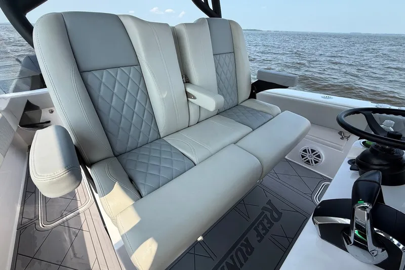 Slide: The Image of Luxury seating on 2023 Reef Runner 34CC boat with quilted upholstery and armrests. - 14