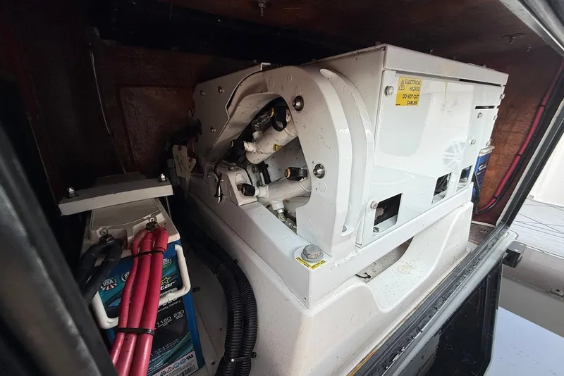 Slide: The Image of Engine compartment of 2023 Reef Runner 34CC boat, featuring electrical components and wiring. - 15