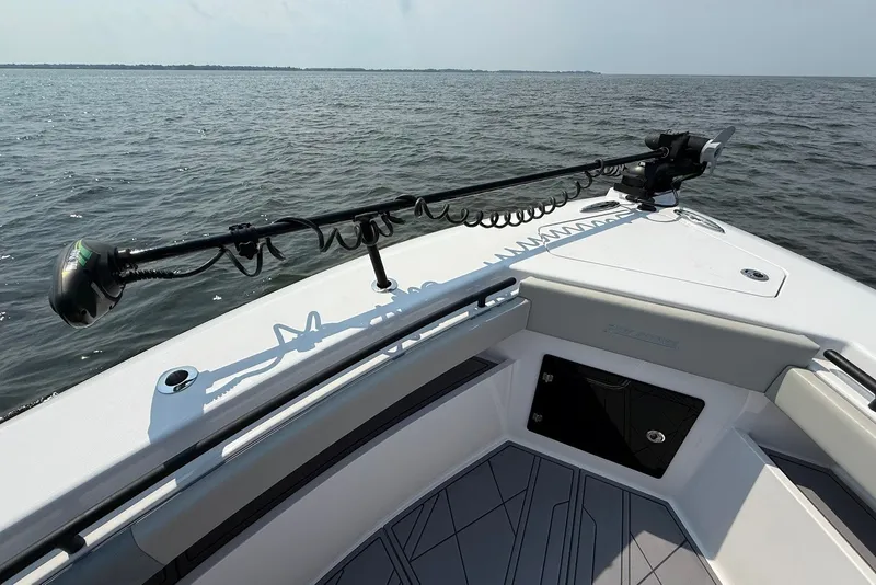 Slide: The Image of 2023 Reef Runner 34CC boat bow with trolling motor on open water. - 23