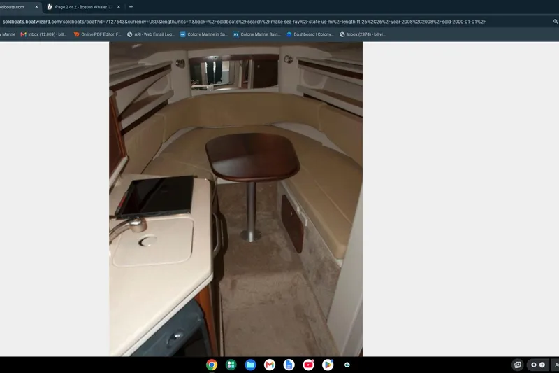 Slide: The Image of Interior of 2008 Sea Ray Sundancer 260, featuring a cozy seating area and compact kitchenette. - 13