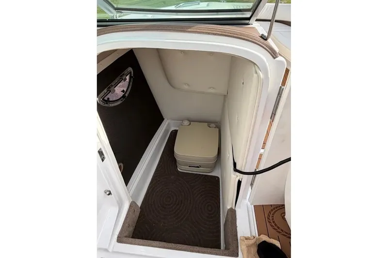 Slide: The Image of Interior of a 2008 Cobalt 252 boat showing a compact restroom area. - 14