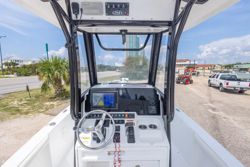 Slide: The Image of 2019 Sea Hunt BX25FS boat dashboard with steering wheel and navigation system. - 23