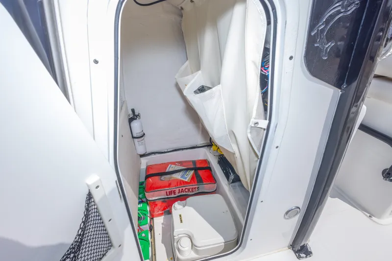 Slide: The Image of Interior storage of 2019 Sea Hunt BX25FS boat with life jackets and fire extinguisher. - 27