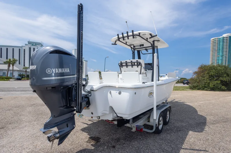 Slide: The Image of 2019 Sea Hunt BX25FS boat with Yamaha engine on trailer, parked outdoors. - 56