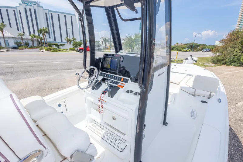 Slide: The Image of 2019 Sea Hunt BX25FS boat cockpit with steering wheel and navigation system. - 49
