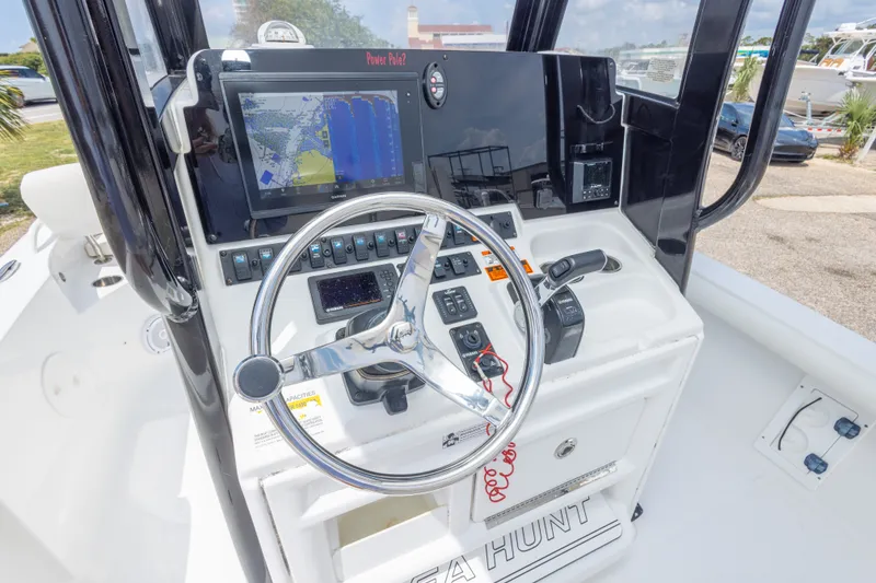 Slide: The Image of 2019 Sea Hunt BX25FS boat console with steering wheel and navigation display. - 21