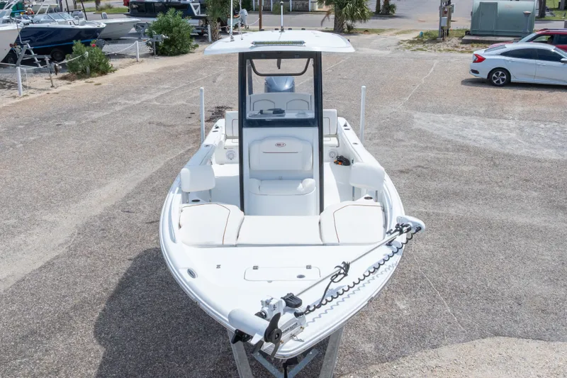 Slide: The Image of 2019 Sea Hunt BX25FS boat on display in a parking area. - 13