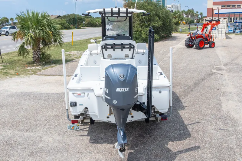 Slide: The Image of 2019 Sea Hunt BX25FS boat with Yamaha 300 engine, parked near palm trees and a tractor. - 58