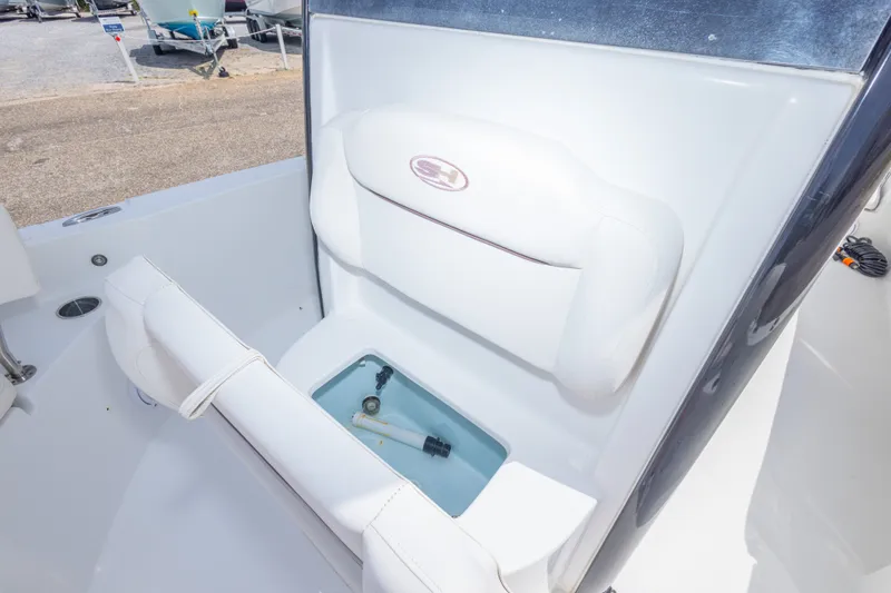Slide: The Image of 2019 Sea Hunt BX25FS boat interior with cushioned seating and storage compartment. - 39
