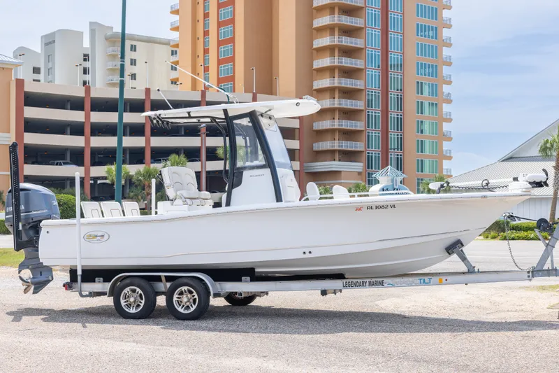 The Image of 2019 Sea Hunt BX25FS boat on trailer, urban background with buildings. - 0