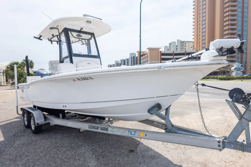 Slide: The Image of 2019 Sea Hunt BX25FS boat on trailer in urban setting. - 10