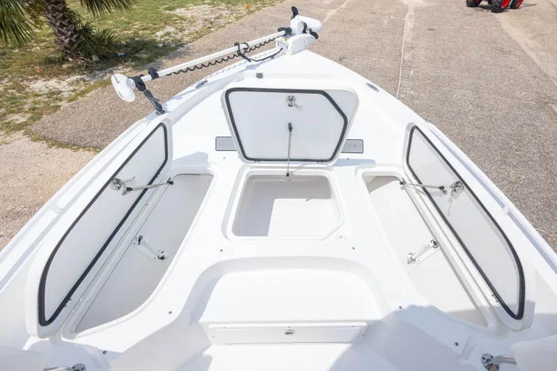 Slide: The Image of 2019 Sea Hunt BX25FS boat with open storage compartments on deck. - 42