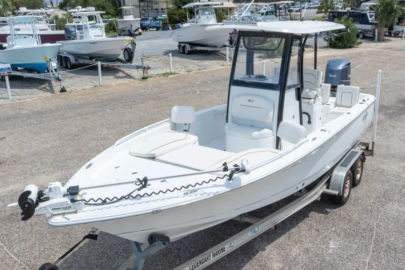 Slide: The Image of 2019 Sea Hunt BX25FS boat on trailer in marina setting. - 2
