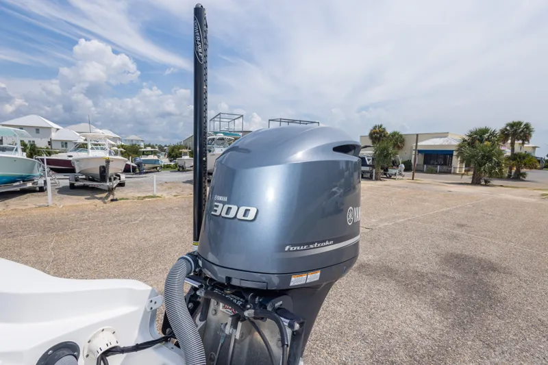 Slide: The Image of 2019 Sea Hunt BX25FS boat with Yamaha 300 four-stroke engine in a marina setting. - 30