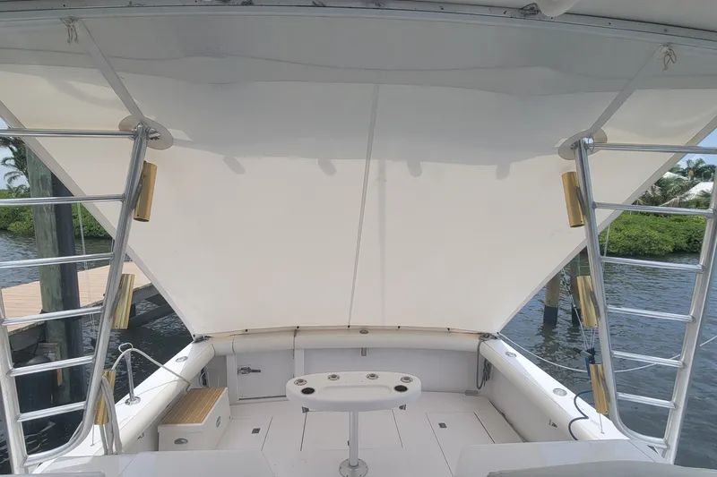 Slide: The Image of 1995 Cabo 35 Express boat interior with ladder and seating area. - 3