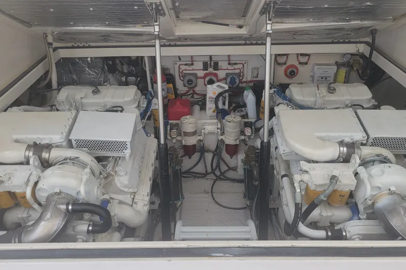 Slide: The Image of Engine room of a 1995 Cabo 35 Express boat, showcasing dual engines and mechanical components. - 8