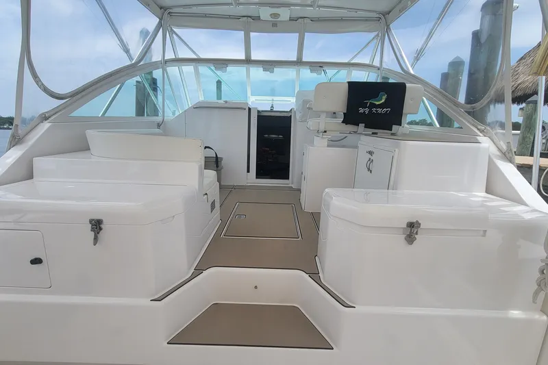 Slide: The Image of 1995 Cabo 35 Express boat interior with seating and helm station. - 6