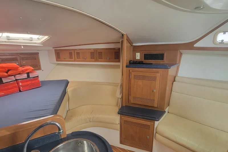 Slide: The Image of Interior of a 1995 Cabo 35 Express boat with seating and storage. - 12