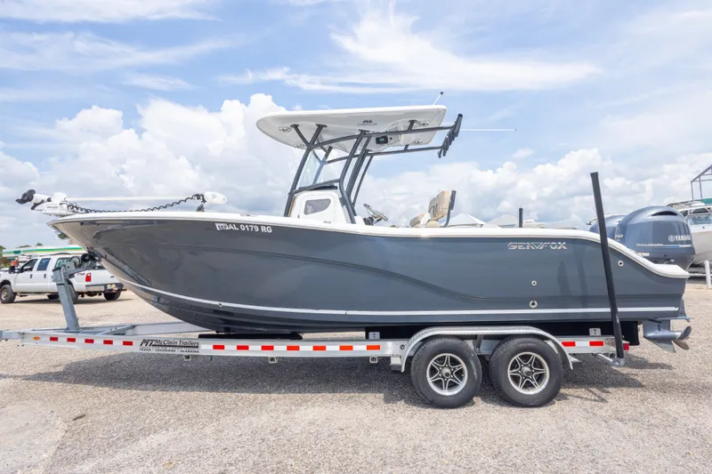 Slide: The Image of 2016 Sea Fox 266 Commander boat on trailer under a cloudy sky. - 15
