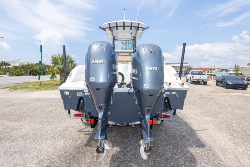 Slide: The Image of 2016 Sea Fox 266 Commander boat with dual Yamaha 150 engines, parked outdoors. - 52