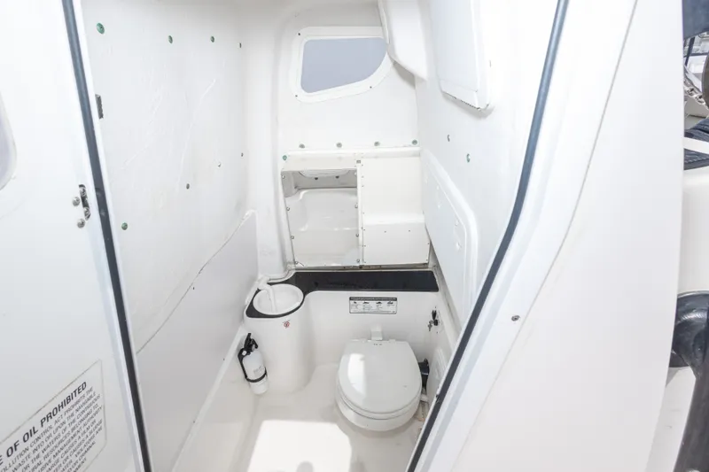 Slide: The Image of Interior of 2016 Sea Fox 266 Commander boat, featuring a compact marine toilet. - 40