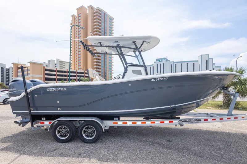 Slide: The Image of 2016 Sea Fox 266 Commander boat on trailer, urban background, clear sky. - 16
