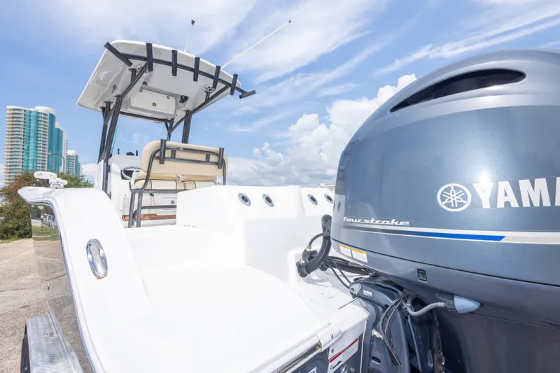 Slide: The Image of 2016 Sea Fox 266 Commander boat with Yamaha engine, docked near modern buildings. - 50