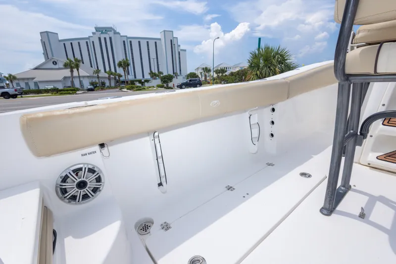 Slide: The Image of 2016 Sea Fox 266 Commander boat interior with speaker, near a coastal hotel. - 22