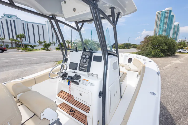 Slide: The Image of 2016 Sea Fox 266 Commander boat with modern console, parked near urban buildings. - 45
