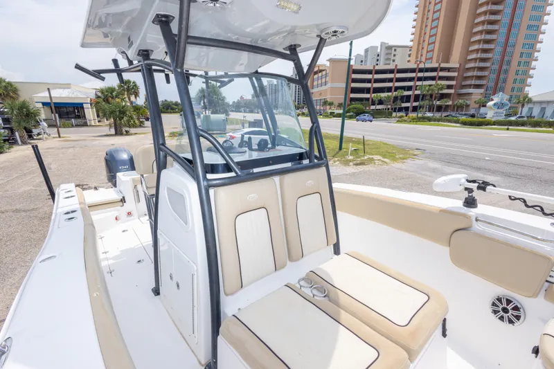 Slide: The Image of 2016 Sea Fox 266 Commander boat with seating and console, parked near a road. - 30