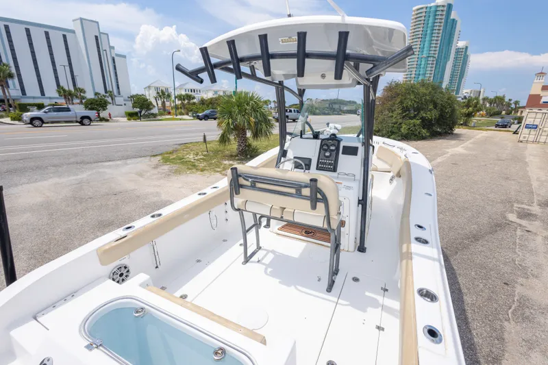 Slide: The Image of 2016 Sea Fox 266 Commander boat with center console, parked near coastal buildings. - 49