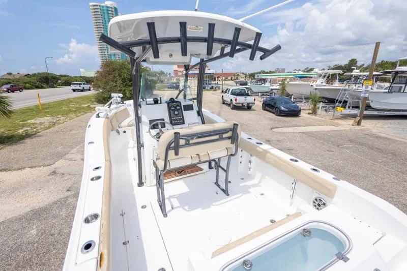 Slide: The Image of 2016 Sea Fox 266 Commander boat docked, featuring spacious deck and modern controls. - 48