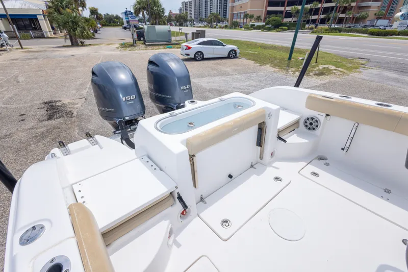 Slide: The Image of 2016 Sea Fox 266 Commander boat with dual 150 horsepower engines, parked near a road. - 24