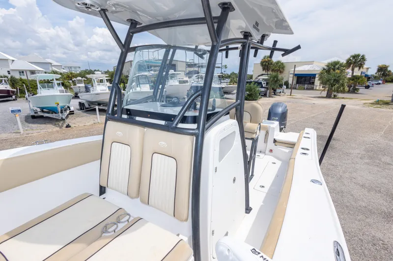 Slide: The Image of 2016 Sea Fox 266 Commander boat with beige seating and center console in a marina. - 29