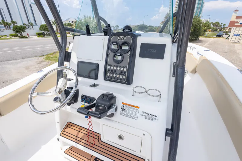 Slide: The Image of 2016 Sea Fox 266 Commander boat console with steering wheel and navigation controls. - 44