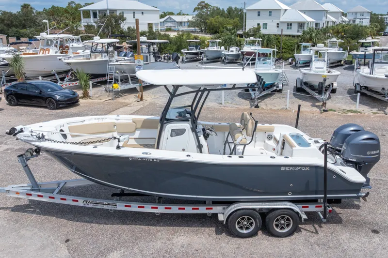 Slide: The Image of 2016 Sea Fox 266 Commander boat on trailer, parked in marina with other boats. - 5