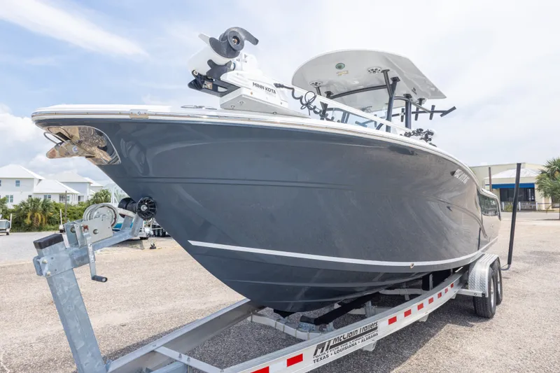 Slide: The Image of 2016 Sea Fox 266 Commander boat on trailer, parked outdoors under a clear sky. - 14
