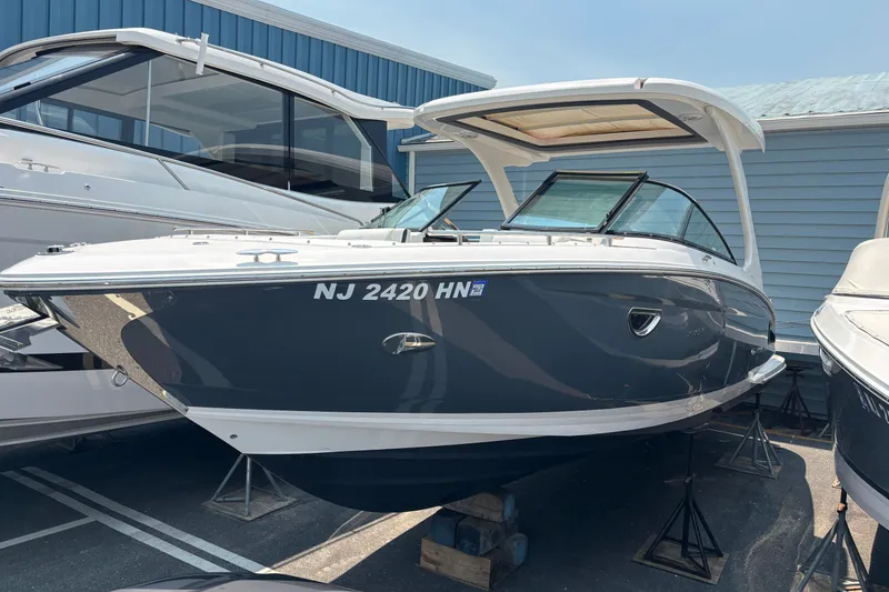 The Image of 2020 Regal 2800 Bowrider boat in marina, sleek design, blue hull, white top. - 0