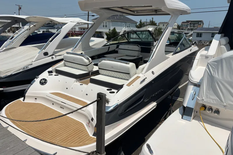 Slide: The Image of 2020 Regal 2800 Bowrider boat docked, showcasing sleek design and spacious seating. - 2
