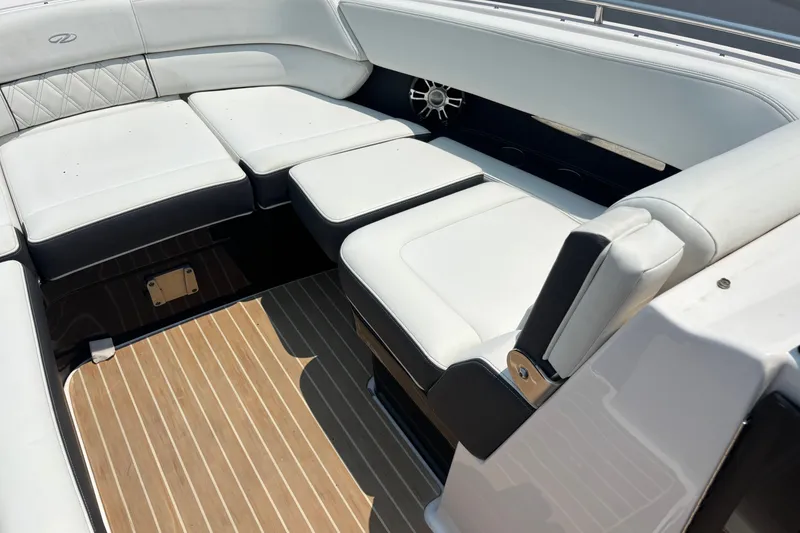 Slide: The Image of 2020 Regal 2800 Bowrider interior with white cushioned seating and wood-patterned flooring. - 9