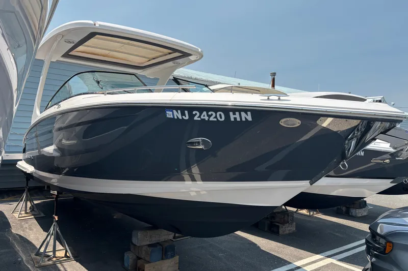 Slide: The Image of 2020 Regal 2800 Bowrider boat on display, parked on stands in a marina. - 1