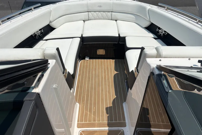 Slide: The Image of 2020 Regal 2800 Bowrider interior with white seating and wooden flooring. - 7