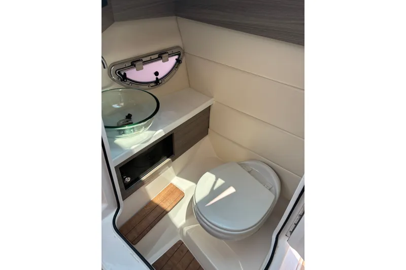 Slide: The Image of 2020 Regal 2800 Bowrider boat bathroom with modern sink and toilet. - 20