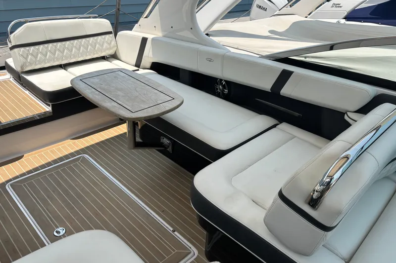 Slide: The Image of 2020 Regal 2800 Bowrider interior with white seating and wooden table. - 15