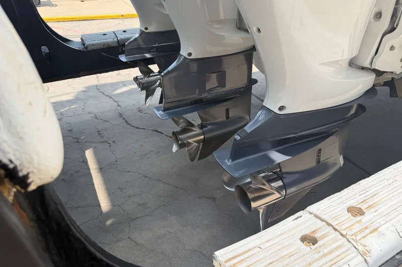 Slide: The Image of 2021 Caymas 341 CC boat engines with dual propellers on a concrete surface. - 9
