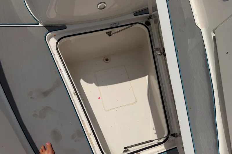 Slide: The Image of Open storage compartment on 2021 Caymas 341 CC boat deck. - 27