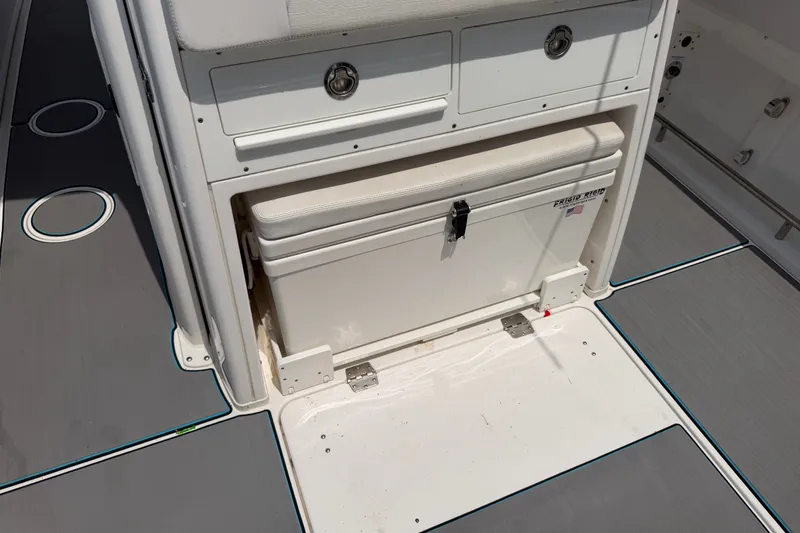 Slide: The Image of 2021 Caymas 341 CC boat interior with storage compartment and cooler. - 59